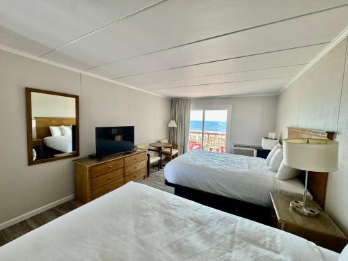 a hotel room with two beds and a television at Flamingo Motel in Ocean City