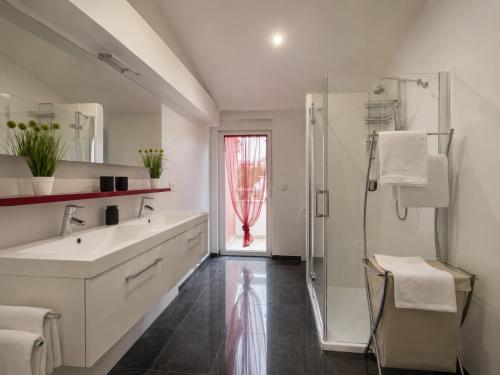 a bathroom with a white sink and a shower at Villa Apricot in Split