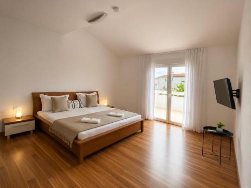a bedroom with a large bed and a sliding glass door at Villa Apricot in Split