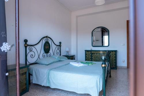 a bedroom with a bed and a mirror at Catania ti aspetta2 in Catania