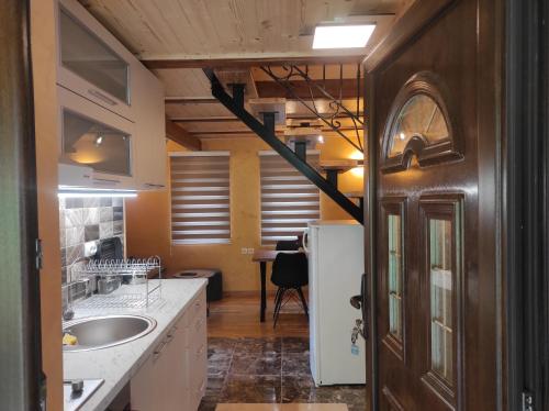 a kitchen with a sink and a refrigerator at Apartmani Slavko in Konjska Reka