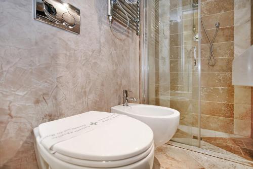 a bathroom with a toilet and a shower at Glamour Suite Duomo in Florence