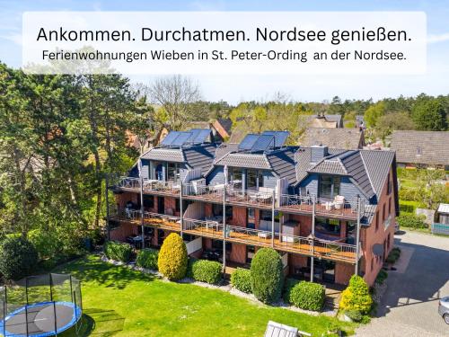 an image of a house with solar panels on its roof at Ferienwohnung Wieben Sankt Peter-Ording in Böhl