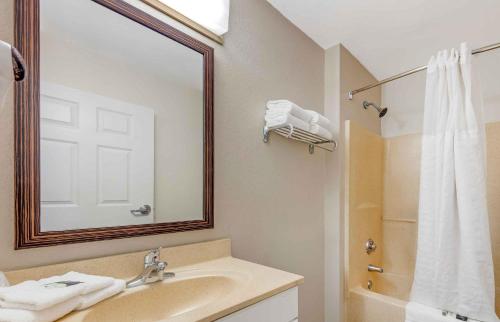a bathroom with a sink and a mirror and a shower at Extended Stay America Suites - West Palm Beach - Northpoint Corporate Park in West Palm Beach