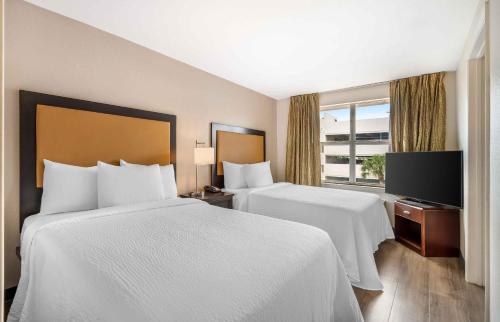 a hotel room with two beds and a window at Extended Stay America Suites - West Palm Beach - Northpoint Corporate Park in West Palm Beach