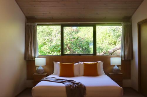 a bedroom with a large bed with a window at Gipsy Point Lakeside in Gipsy Point