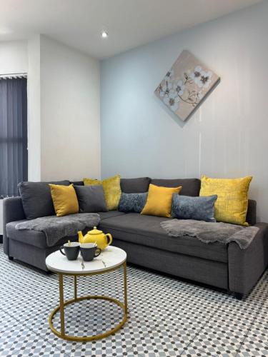 a living room with a couch and a table at Dove & Gold in Gloucestershire