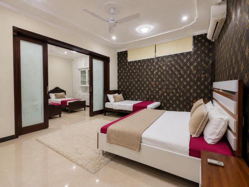 a bedroom with two beds and a living room at The 430 Nexus in Islamabad