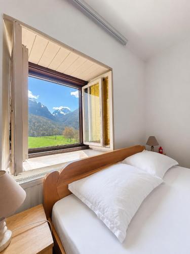 a bedroom with a bed and a large window at Heaven Retreat in Vusanje
