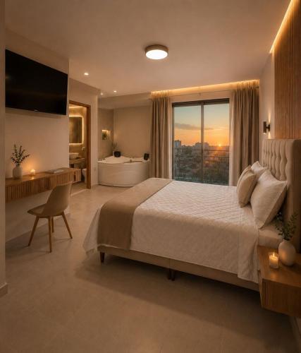 a bedroom with a large bed and a large window at Centrica Suite Hotel in Huarmey