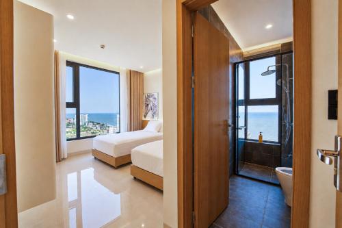 a bedroom with two beds and a view of the ocean at The Pathway Condotel in Sầm Sơn