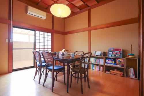 a dining room with a table and chairs at サウナ&ステイ吉日荘-益子町のプライベートサウナ付の貸切古民家 BBQ 高速Wi-fi in Mashiko