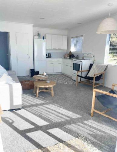 a living room with a couch and a kitchen at Herea Bunker in Turangi