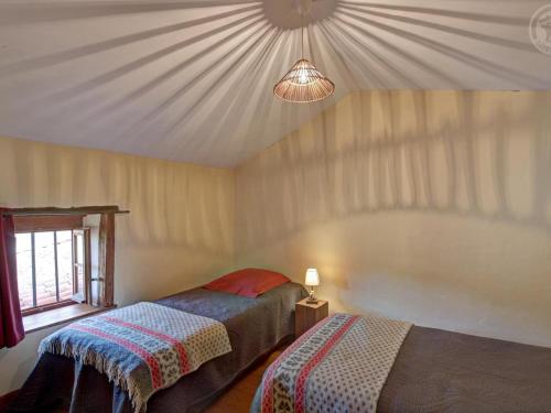 a bedroom with two beds in a room with a ceiling at Gîte de charme rénové 3 épis, 2 chambres en pleine nature - FR-1-496-92 in Palogneux