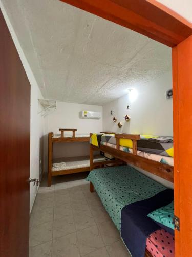 a room with two bunk beds and a door at Apartamentos Rincón Garcia in Cartagena de Indias