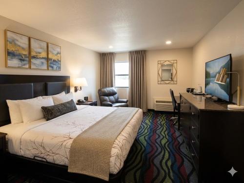 a hotel room with a bed and a desk at Apple Tree Inn in Independence