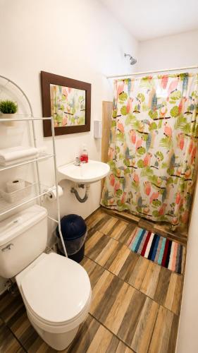 a bathroom with a toilet and a sink at Aloha Popoyo in Playa Santana