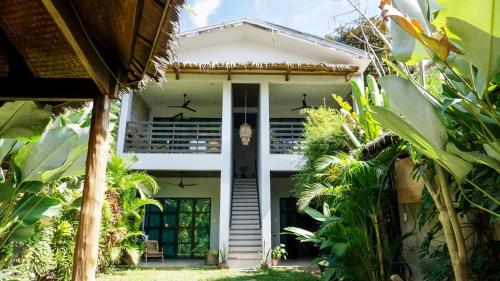 a house in the middle of a garden at Happiness Villas in El Nido