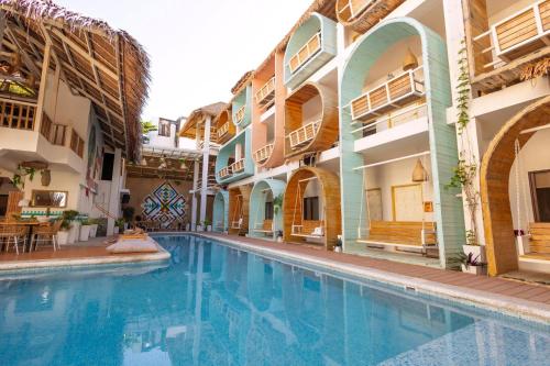 a swimming pool in the middle of a building at Happiness Hostel Boracay in Boracay