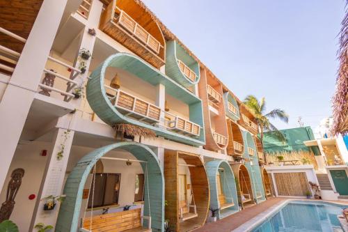 a building with a swimming pool in front of it at Happiness Hostel Boracay in Boracay