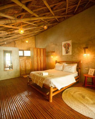 a bedroom with a large bed in a room at Happiness Native Villa in El Nido