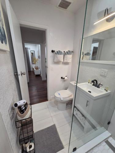 a white bathroom with a sink and a toilet at Varadero Magical Scape in Miami