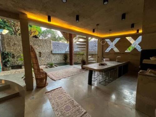 a living room with a table and a couch at Happiness Kulambo Villa El Nido in El Nido