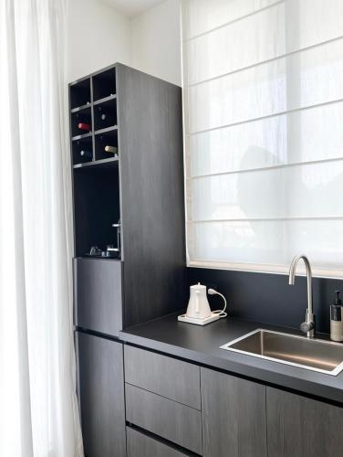 a kitchen with a sink and a window at NOAM by the sea in Tamarindo