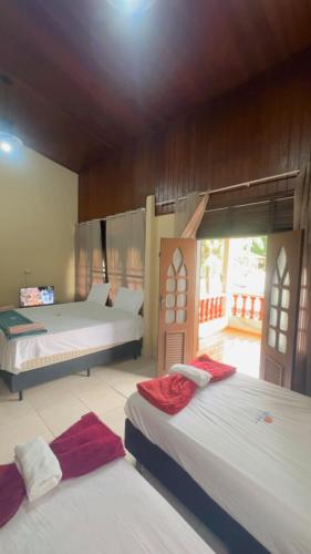 a bedroom with two beds and a window at Hotel Porto Arthur in Belém