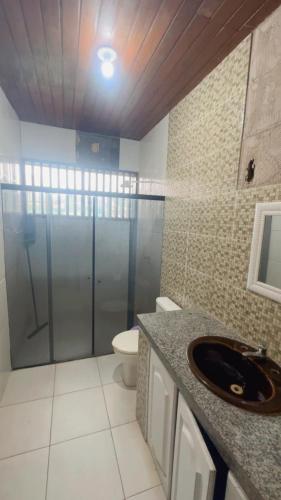 a bathroom with a shower and a sink and a toilet at Hotel Porto Arthur in Belém