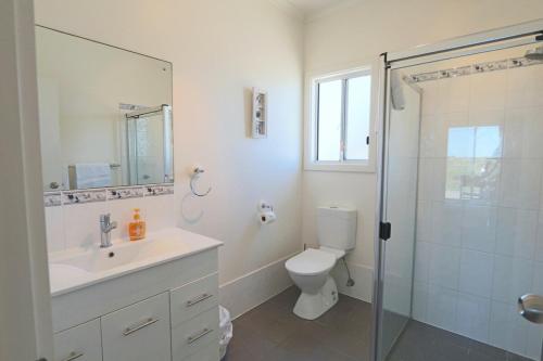 a bathroom with a toilet and a sink and a shower at '128 The Esplanade' - Beachside holiday home with swimming pool in Robe in Robe