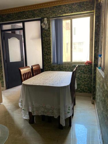 a dining room with a table and two chairs at Soaltee city apartments in Kathmandu