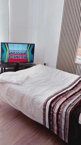 a bedroom with a bed with a flat screen tv at AAA lodge in Middlesbrough