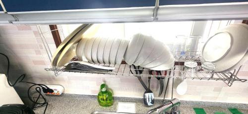 a kitchen counter with dishes on a drying rack at Stay something in Ch'ŏnbu-ri