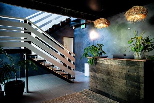 a staircase in a room with potted plants at HaKu in Brunswick Heads