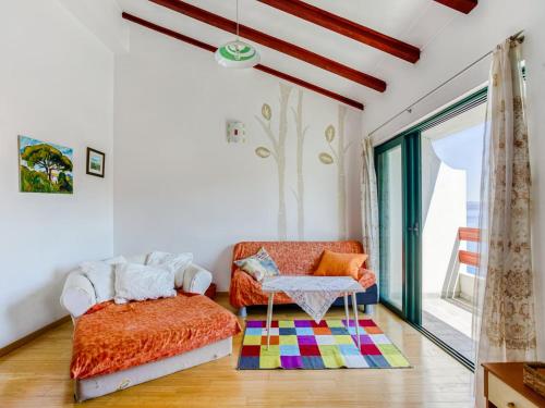 a living room with a couch and a chair at Alluring Apartment by the Sea in Stomorska