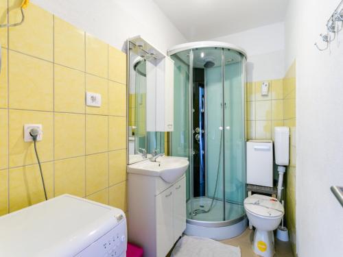 a bathroom with a shower and a toilet and a sink at Alluring Apartment by the Sea in Stomorska