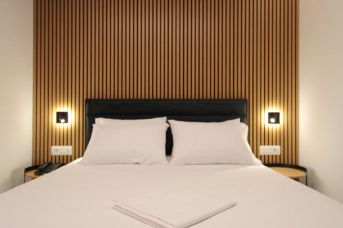 a bed with two white pillows in a bedroom at Valmar Hotel in Ksamil