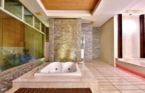 a large bath tub in a room with at Vogue Boutique Motel in Yangmei