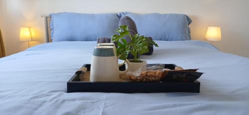 a tray of food on top of a bed at Mike's Place at Marina Spatial in Dumaguete