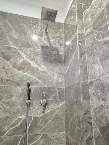 a shower with a shower head in a bathroom at Crown Villa in Golem