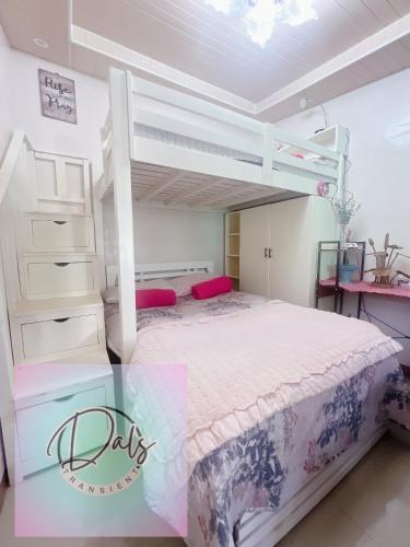 a bedroom with a white bunk bed in a room at Dals Accommodation pad in Baguio