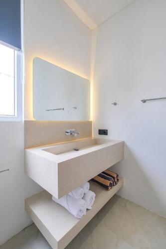 a bathroom with a sink and a mirror at Blanca Karma Villas in Uluwatu