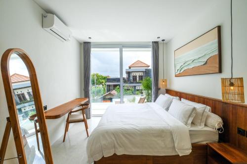 a bedroom with a bed and a large window at Blanca Karma Villas in Uluwatu