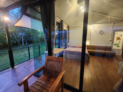 a room with a bed and a chair and a window at Porjai's Lakeview in Phetchabun