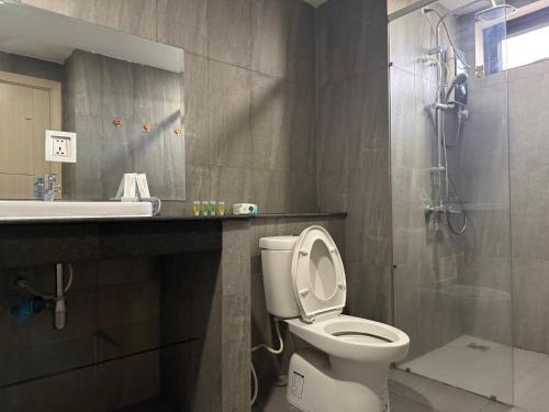 a bathroom with a toilet and a sink and a shower at Skyline hotel in Phnom Penh
