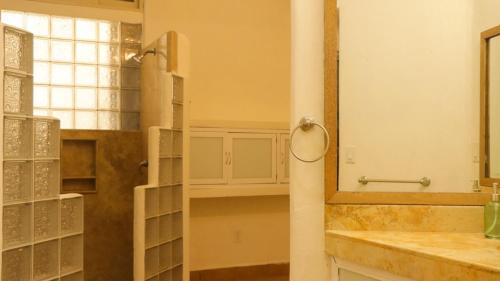 a bathroom with a sink and a mirror at Aguamiel Manzanillo in Puerto Escondido