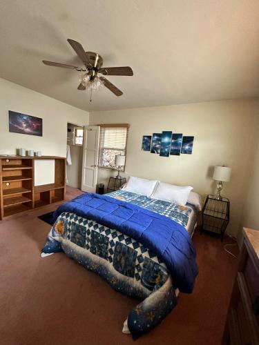 a bedroom with a bed and a ceiling fan at Sacred Heart House in Montebello
