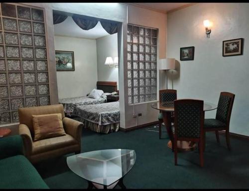 a hotel room with a bed and a living room at DJ Paradise Hotel in Tikay