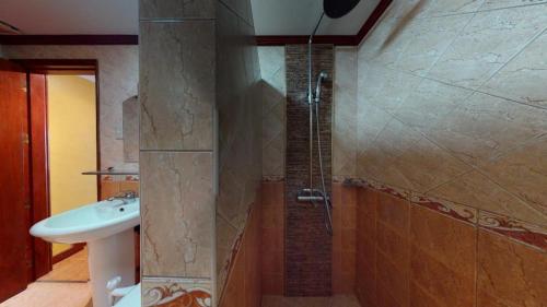 a bathroom with a sink and a shower at Swiss Chalet in Angeles